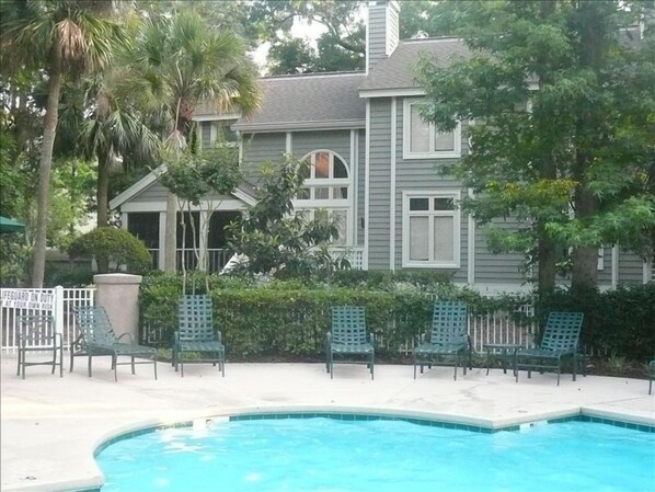 Back of our Villa showing screened porch, 2 story living room window and pool.