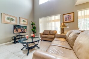 Family room features 50'' LCD cable TV, leather sofa and tiled floor