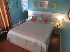 master bedroom with queen bed. Patio doors lead to side deck.