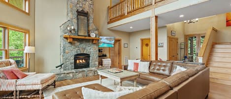 Two Story Stone Gas Fireplace in the open concept first floor. 