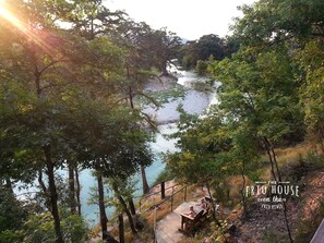 View of the Frio River and sitting area from the deck at The Frio House. 