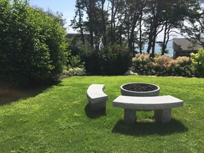 Professionally landscaped grounds complete with granite gas fire pit and benches