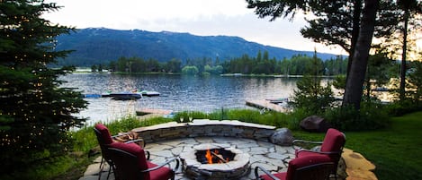 Brand new rock patio and fire pit by the lake to sit and watch the sunset.