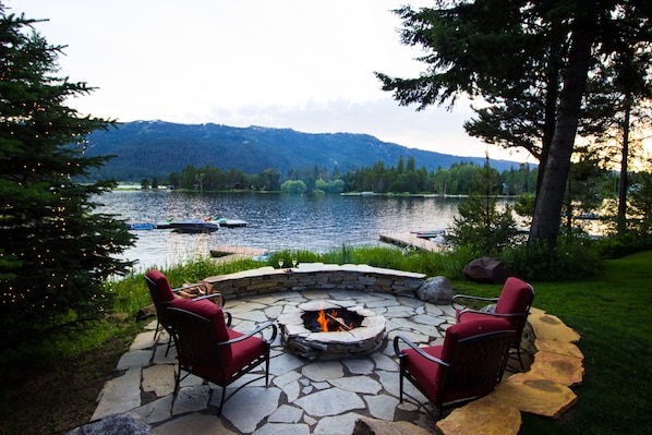 Brand new rock patio and fire pit by the lake to sit and watch the sunset.