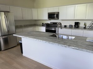 Spacious kitchen with plenty of pots and pans, air fryer,  blender, crock pot…
