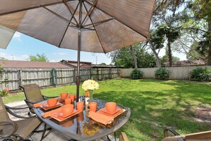 Outdoor dining with beautiful oversized fenced back yard for privacy and fun