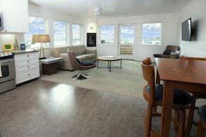 The spacious living room has a large flat-screen TV, fireplace and comfy seating