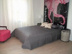 Queen platform bed with new mattress, great chair for reading, flat screen tv.