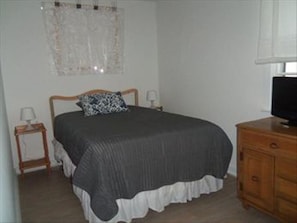 Full-size bed with new mattress, flat screen tv