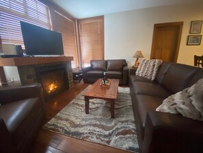 Living room, fireplace, new leather couches and chair 