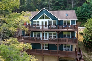 View of the Back of the house from lake side. 3 full decks. 2 grills. Hot Tub. 
