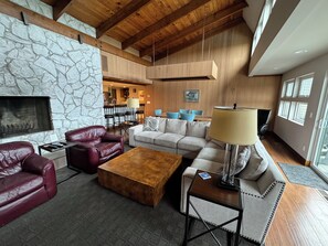 Great room with large fireplace and dining open to kitchen area.