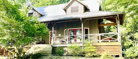 Summer view of the farmhouse. The big porch is great to hang out on.