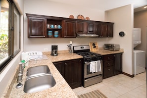 Kitchen with stainless steel appliances and gorgeous cabinets.