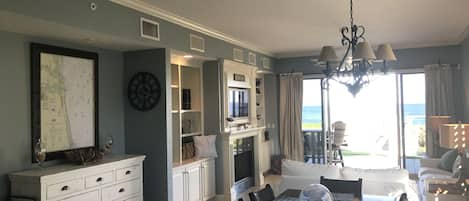 Blue-gray living and dining area with fireplace, perfect for entertaining.