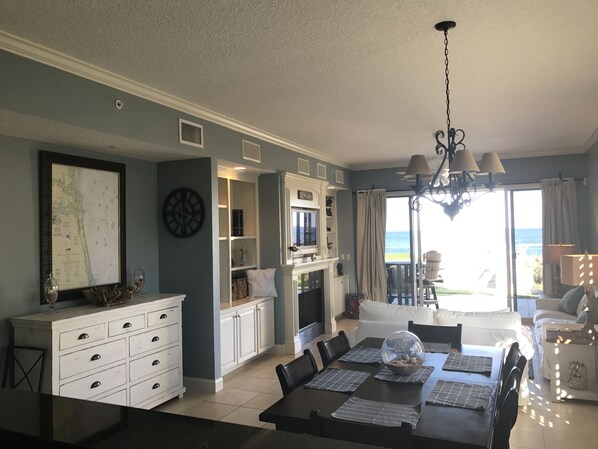 Blue-gray living and dining area with fireplace, perfect for entertaining.