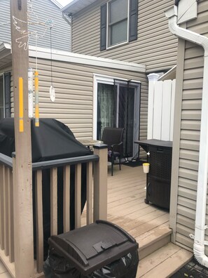 Sliders to house in back, outdoor shower, bistro table with seating for 2