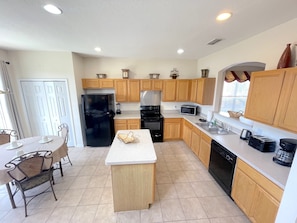 Large open kitchen with view of the private pool