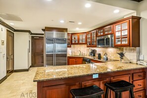 Kitchen w/sub zero fridge, top of the line appliances, and granite counter tops