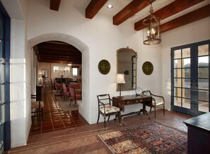 Rustic wooden beams and rounded arches reflect old-world charm.