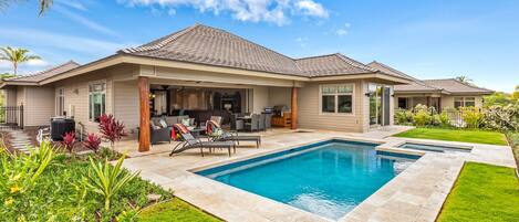Wide angle view of pool, spa, garden, lanai, and exterior of the estate home.