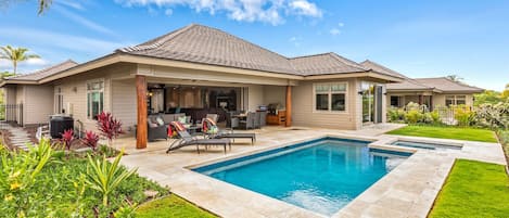 Wide angle view of pool, spa, garden, lanai, and exterior of the estate home.