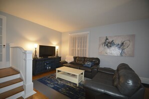 Spacious living area with new leather couches and cable TV 