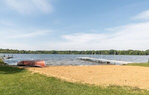 Sunset Shores Lake House private beach with canoe and dock