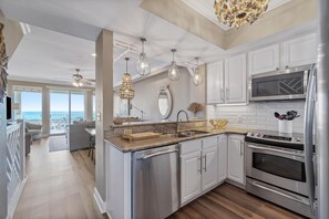 Well appointed kitchen open to living and dining with an amazing view.