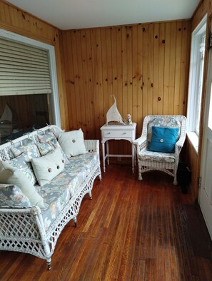 Comfortable wicker furn on Front enclosed porch