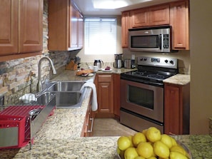 Fully equipped kitchen with stainless steel appliances and granite counter tops