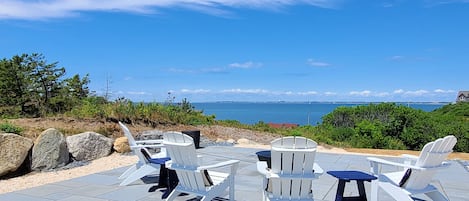 Gorgeous upper patio with Adironack chairs and a panoramic bay view