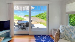 Slider from family room leads to deck and path to upper patio