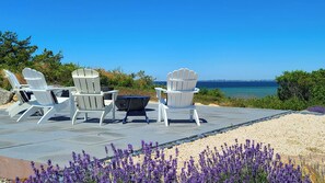 Gorgeous upper patio with Adironack chairs and a panoramic bay view