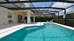 Large private pool with sun loungers and dining area