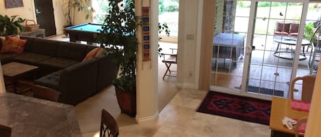 Main living space has travertine stone tile, wall to wall carpet and cherry wood