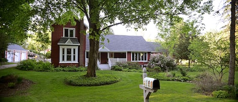 The front of the house view from the road.  Swim pond in the back on the left.
