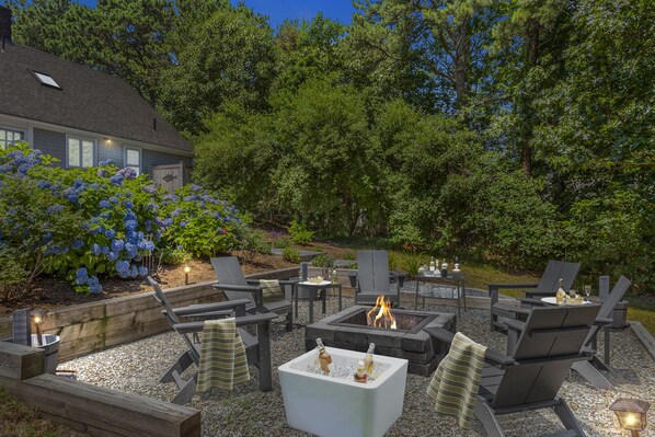 Night view of the outdoor fire pit- Sip and Savor fireside moments.