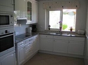 Kitchen looking out to rear garden and golf course
