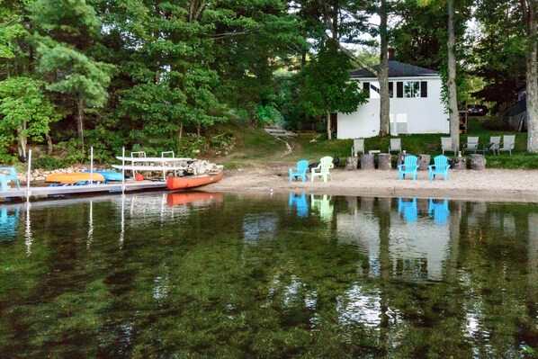 Lake Side  Sandy swimming area.  The dark spots are leaves from recent storm