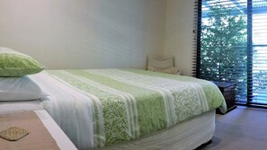 Queen size pillow top bed overlooking garden