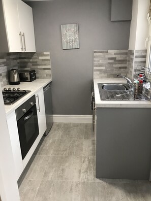 Newly installed kitchen with dishwasher, oven, hob, fridge, microwave etc