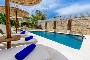 Wonderful sunbathing terrace equipped with sun beds and umbrellas.