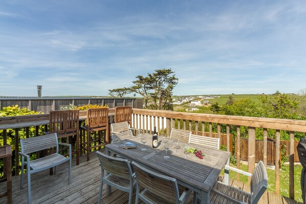 Spacious wooden balcony, with lovely views, inbuilt bar seating and gas barbecue