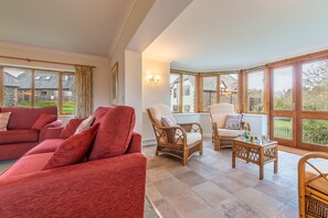 September Cottage, Roserrow. Ground floor: Sitting room leading to conservatory