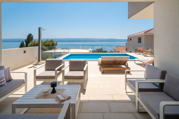 Covered lounge seating area with open sea view