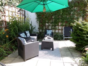 New patio set 2024 very sunny area but with a large parasol.