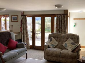 Living room with two 2 seater settees and french doors