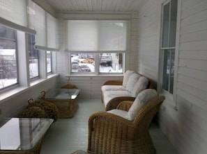 Enclosed three season porch shared by both units