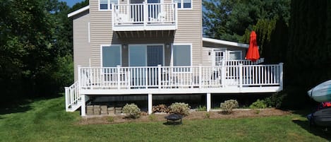 Beautiful yard with wrap around deck right on the lake.